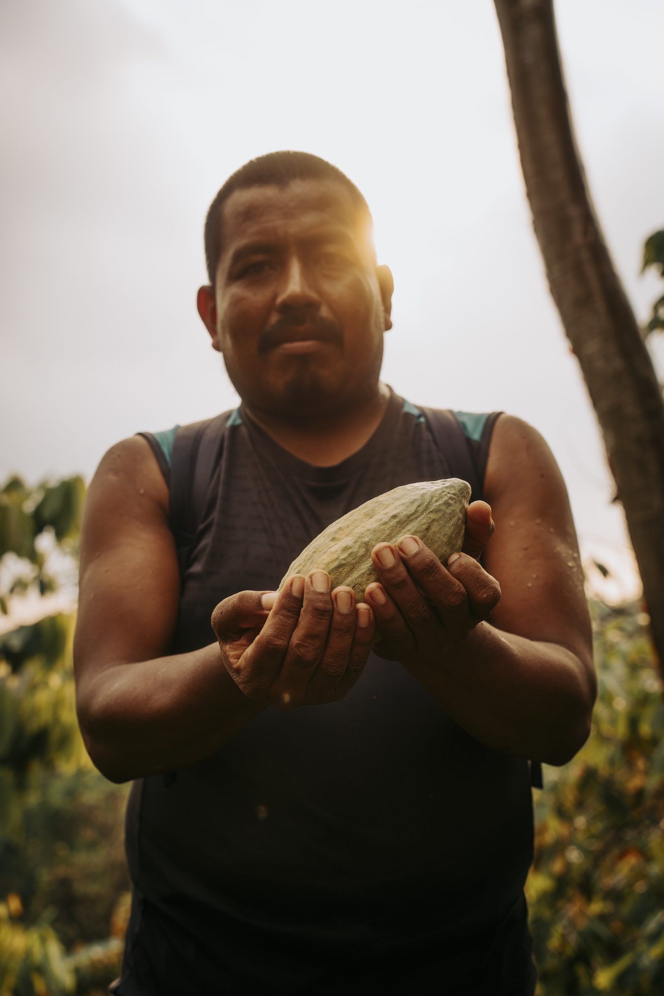 Byron, head of our cacao collective, holding a freshly harvested cacao pod